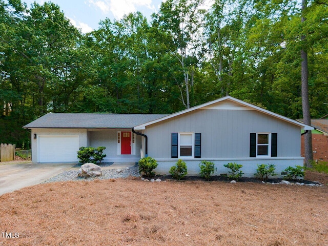 ranch-style house featuring a garage, driveway, and brick siding