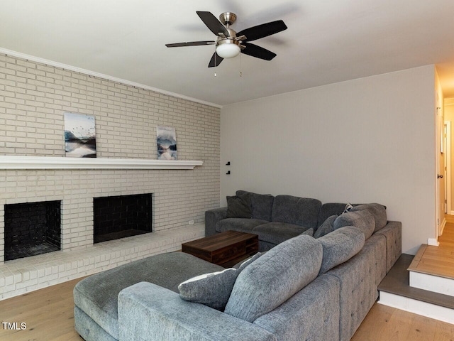 living room with ceiling fan, wood finished floors, and a fireplace