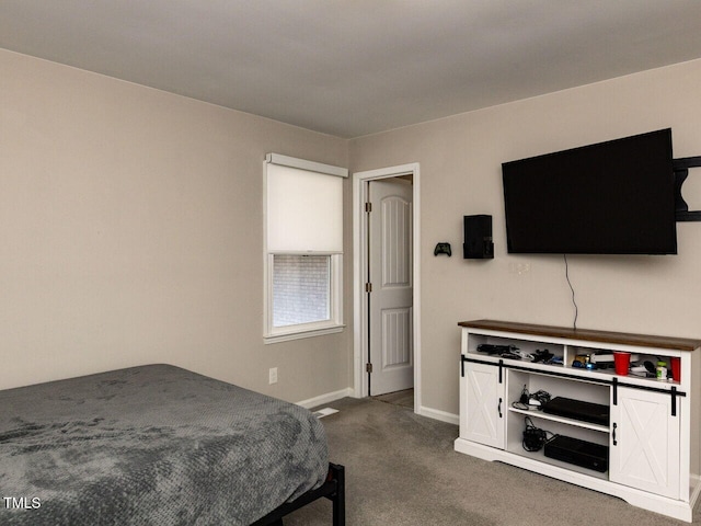 bedroom with baseboards and dark carpet
