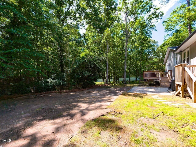 view of yard featuring stairway and a wooden deck