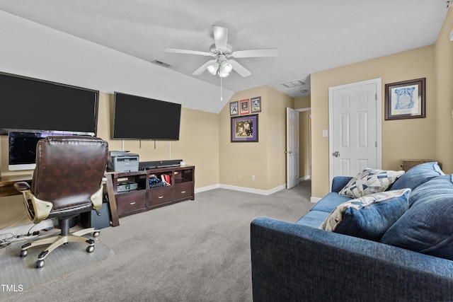 office space featuring carpet floors, a ceiling fan, baseboards, vaulted ceiling, and visible vents