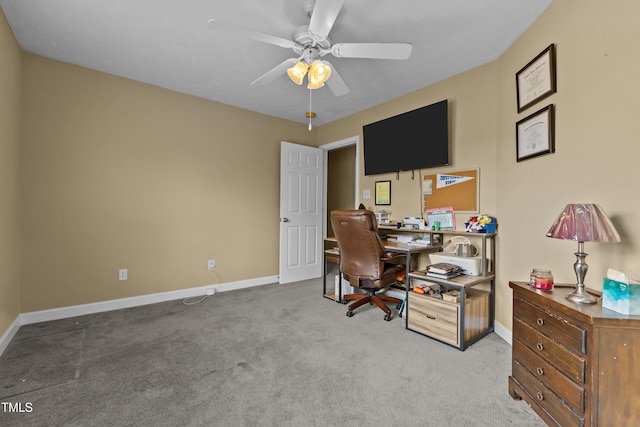 office area featuring a ceiling fan, baseboards, and carpet