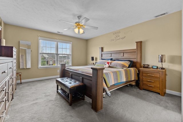 carpeted bedroom featuring visible vents, baseboards, and ceiling fan