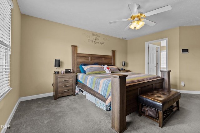 carpeted bedroom featuring baseboards and a ceiling fan