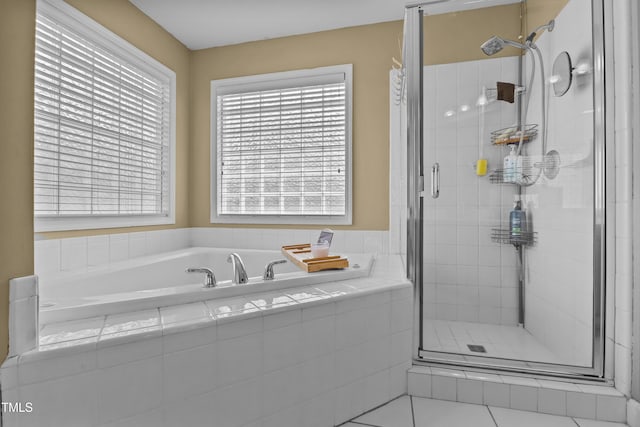 full bathroom featuring a wealth of natural light, a bath, and a stall shower