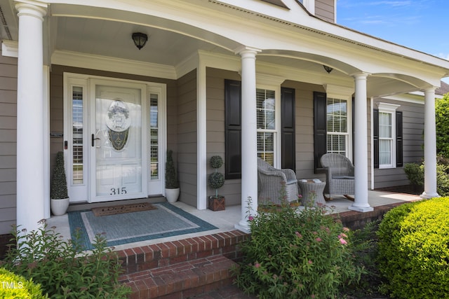 view of exterior entry with a porch
