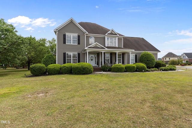 view of front of house with covered porch and a front yard