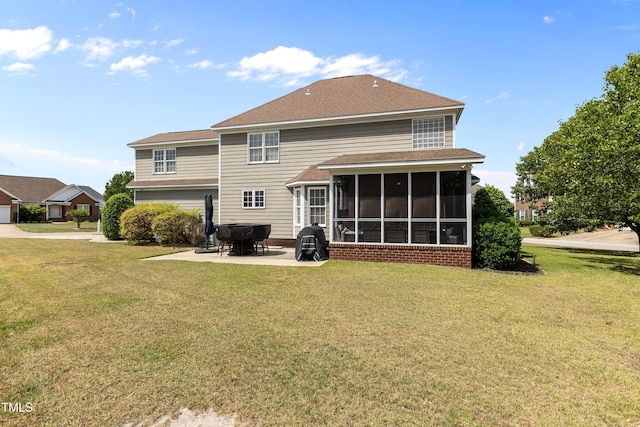 back of house featuring a yard, a patio, and a sunroom