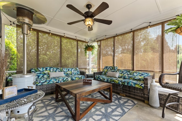 sunroom featuring a ceiling fan, plenty of natural light, and an outdoor hangout area