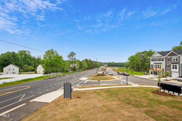 view of road with sidewalks and street lighting
