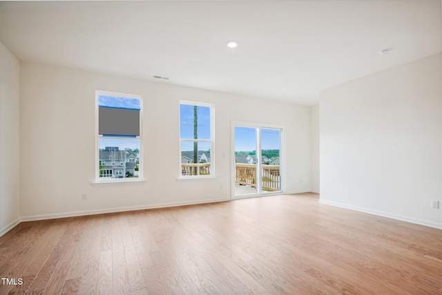 unfurnished room featuring light wood-style floors, recessed lighting, baseboards, and visible vents