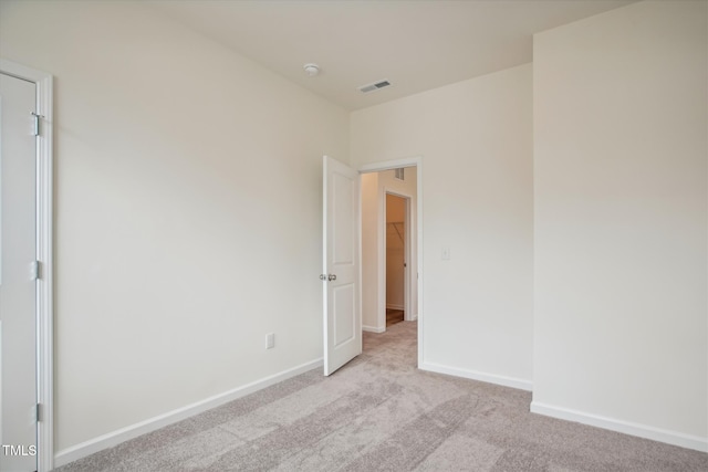 unfurnished bedroom featuring baseboards, visible vents, and carpet