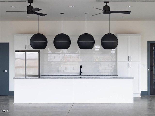 1024 Channel Drop, Zebulon, NC 27597 - kitchen with freestanding refrigerator, white cabinetry, and ceiling fan