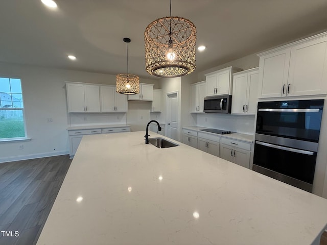 1024 Channel Drop, Zebulon, NC 27597 - kitchen featuring black appliances, a chandelier, white cabinetry, dark wood-style flooring, and light stone counters