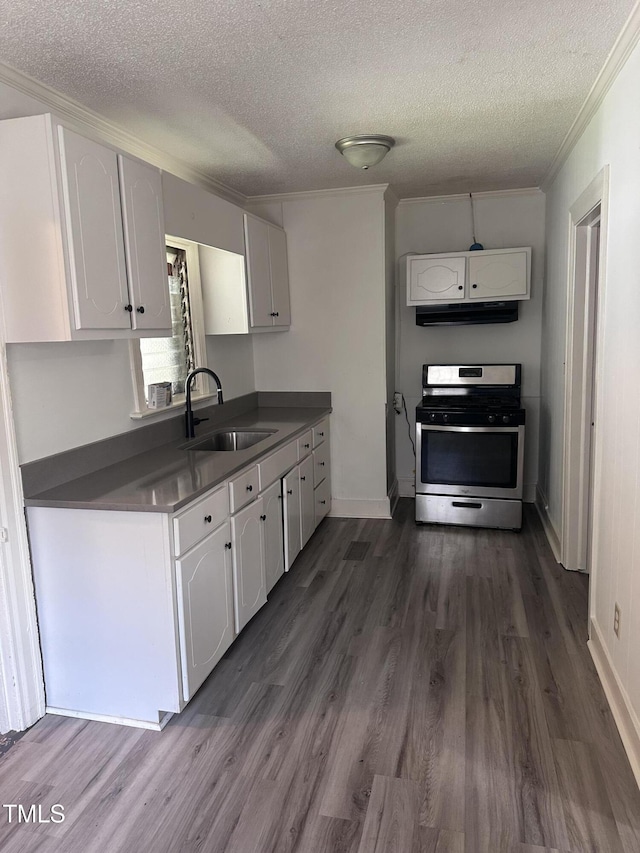 kitchen with a textured ceiling, dark wood finished floors, a sink, stainless steel gas range, and white cabinets