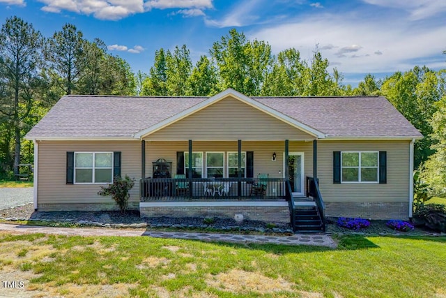 view of front of house featuring a porch, a front lawn, roof with shingles, and stairs