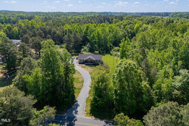 aerial view of property and surrounding area with a forest