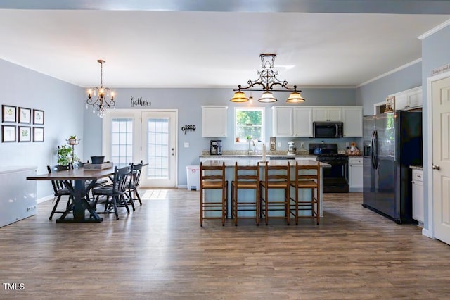 dining space with a chandelier, crown molding, plenty of natural light, and dark wood-style flooring