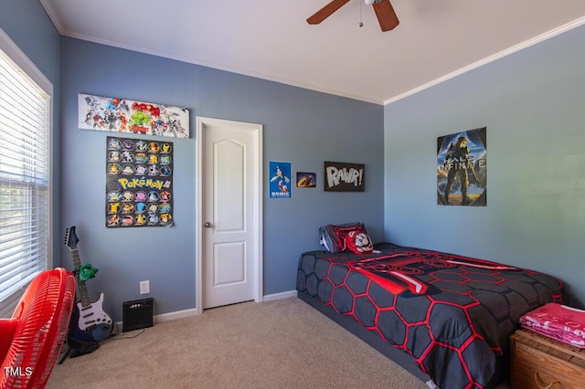 bedroom featuring crown molding, carpet floors, baseboards, and a ceiling fan