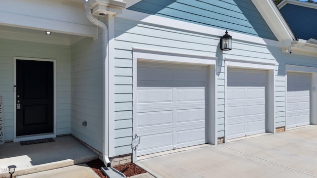 garage featuring concrete driveway