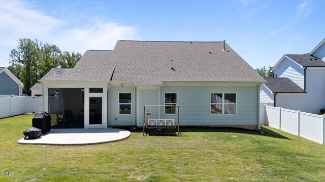 rear view of property with a patio area and roof with shingles