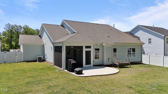 back of house with a gate, roof with shingles, central AC unit, and a patio area