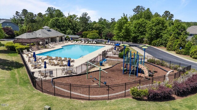 community pool with fence and a patio area