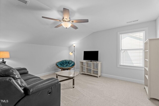 living room featuring lofted ceiling, a ceiling fan, carpet, and baseboards