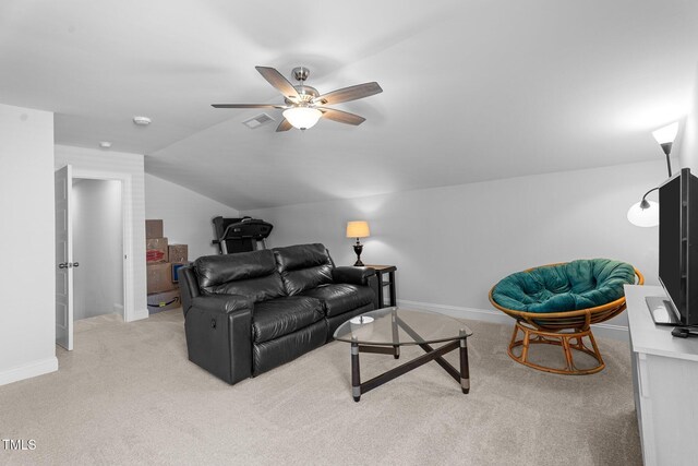living area featuring light carpet, vaulted ceiling, ceiling fan, and baseboards