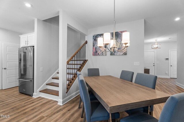 dining space with a chandelier, stairway, wood finished floors, baseboards, and recessed lighting