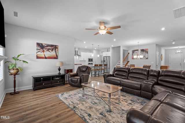 living room with a chandelier, wood finished floors, ceiling fan, baseboards, and recessed lighting