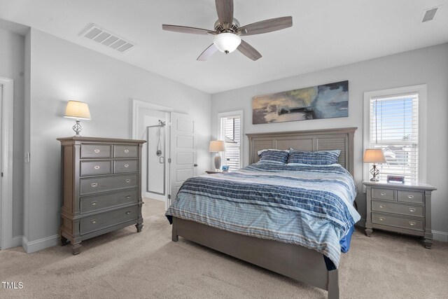 bedroom with light carpet, baseboards, and a ceiling fan