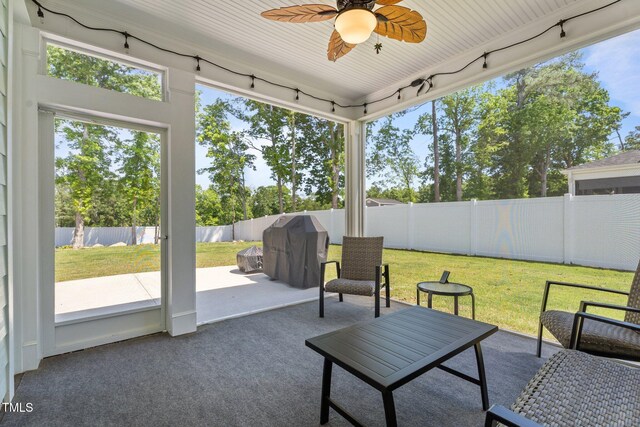sunroom with track lighting and a ceiling fan