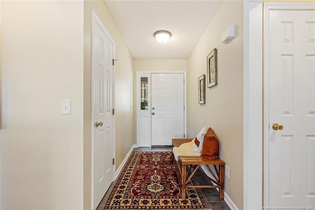 doorway to outside with baseboards