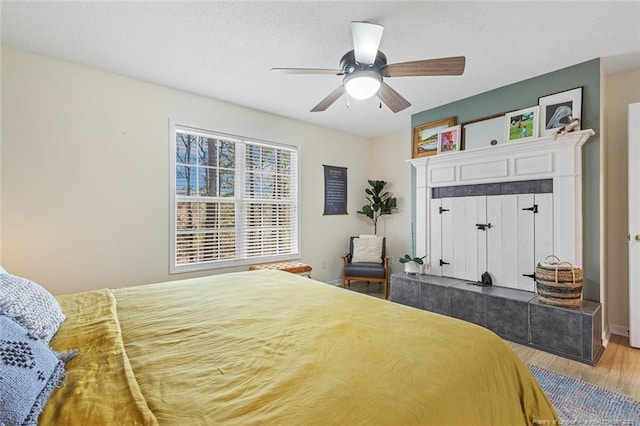 bedroom featuring a ceiling fan and wood finished floors