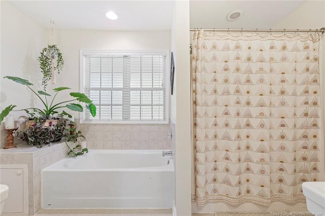 bathroom featuring recessed lighting, a shower with shower curtain, a bath, and toilet