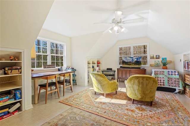 sitting room featuring ceiling fan, tile patterned floors, lofted ceiling, and built in shelves