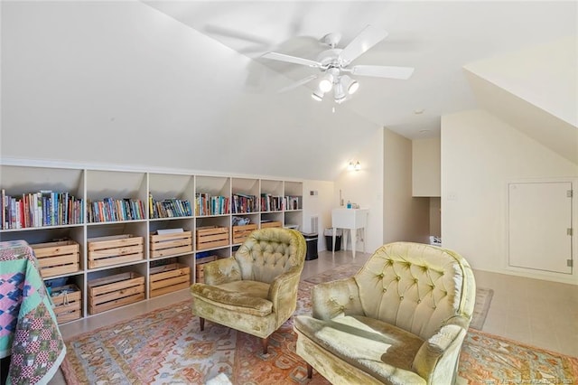 living area with ceiling fan and lofted ceiling
