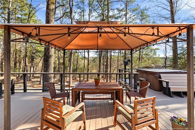 wooden deck with a hot tub and outdoor dining space