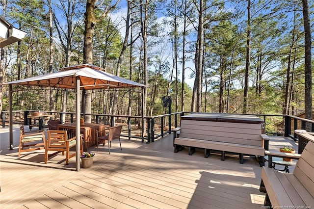 deck with a hot tub and a gazebo