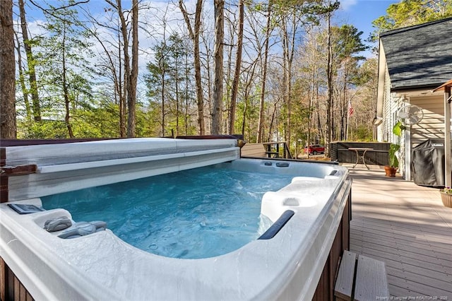 view of swimming pool featuring a hot tub