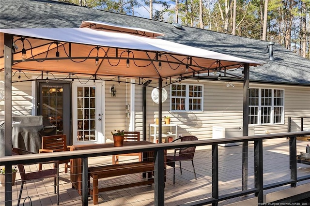deck with a gazebo and outdoor dining area