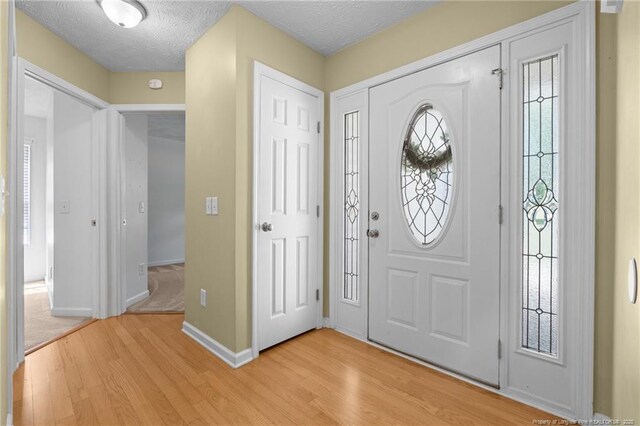 481 Clearwater Harbour, Sanford, NC 27332 - entrance foyer featuring light wood-style flooring, baseboards, and a textured ceiling