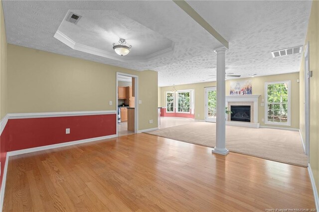 481 Clearwater Harbour, Sanford, NC 27332 - unfurnished living room featuring a textured ceiling, healthy amount of natural light, baseboards, and wood finished floors