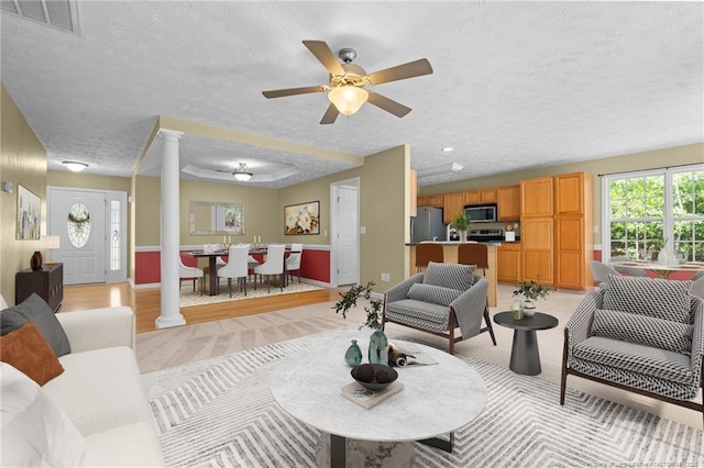 481 Clearwater Harbour, Sanford, NC 27332 - living room featuring decorative columns, a textured ceiling, ceiling fan, and baseboards