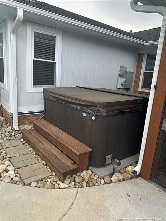exterior space featuring a jacuzzi
