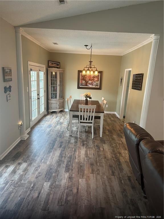 dining room with crown molding, dark wood finished floors, and baseboards