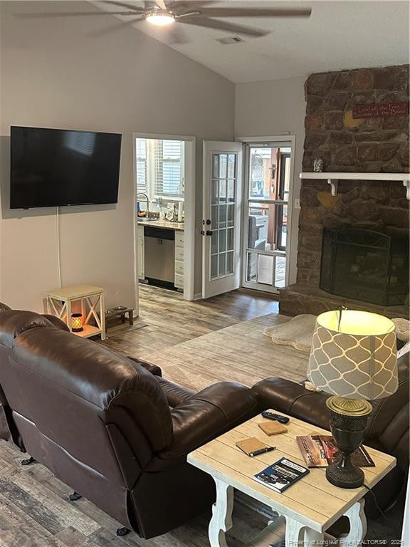 living area with vaulted ceiling, wood finished floors, and ceiling fan