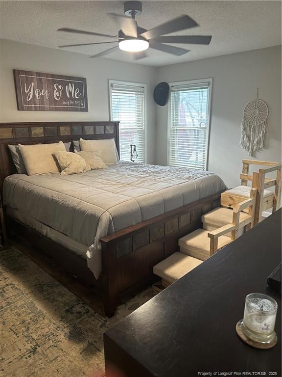 bedroom featuring a textured ceiling and ceiling fan