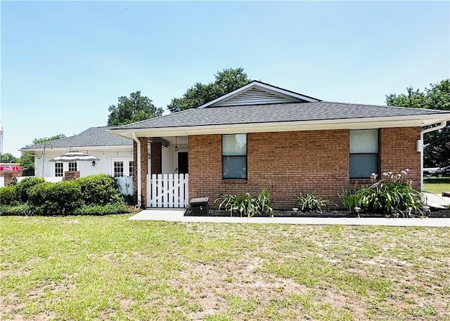 5706 Archer Rd, Hope Mills, NC 28348 - view of front of house with brick siding, a front lawn, and roof with shingles